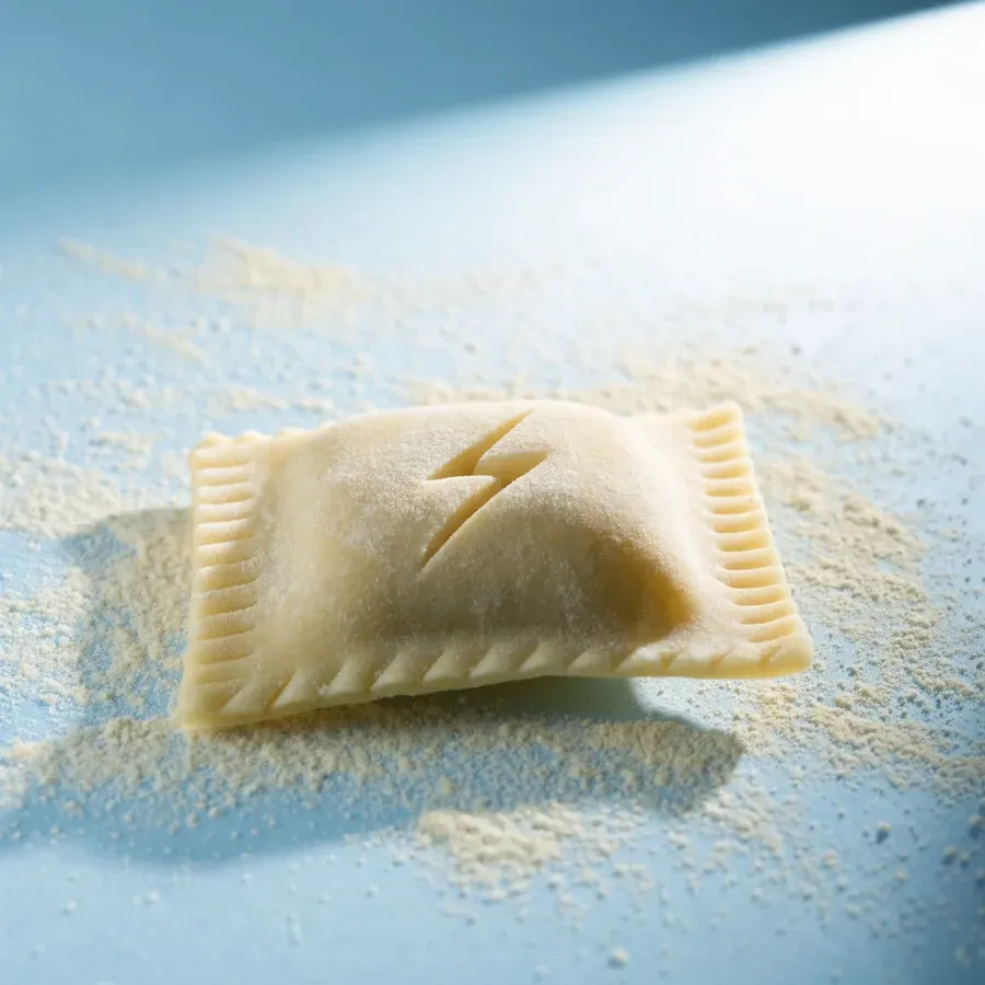 A fresh ravioli with a lightning bolt carved into the dough