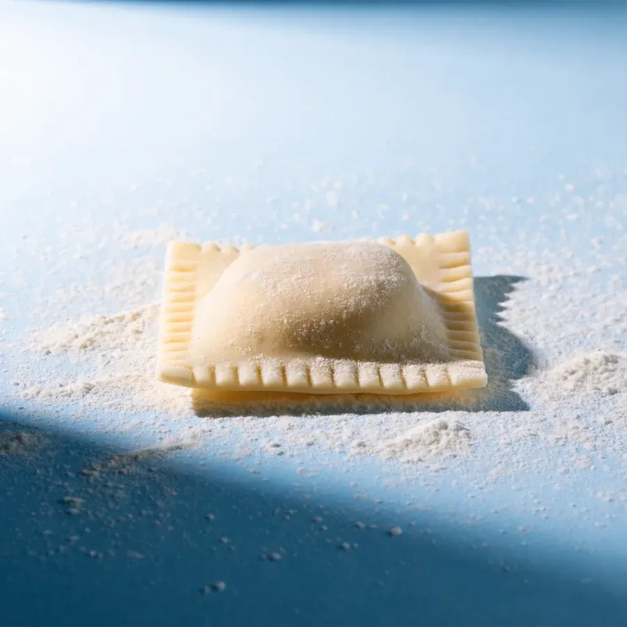 A plain fresh ravioli, uncarved
